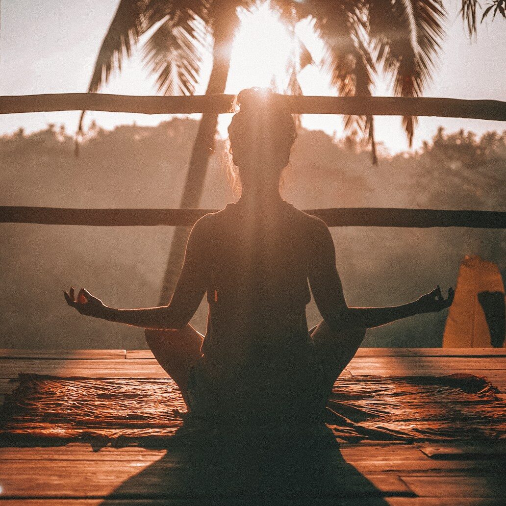 woman doing yoga meditation on brown parquet flooring